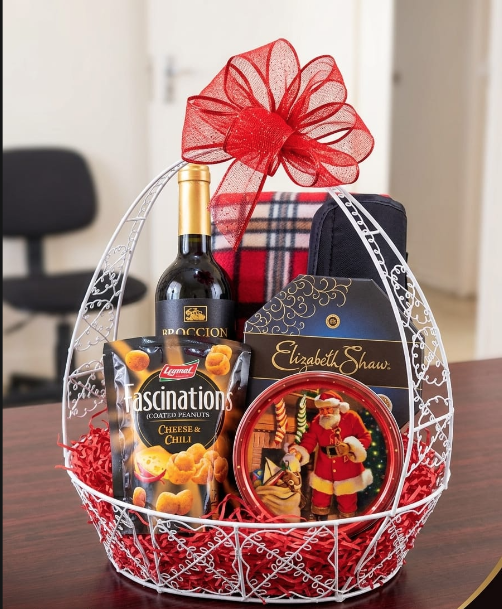 Round wire gift basket with wine, snacks and festive chocolates, red bow