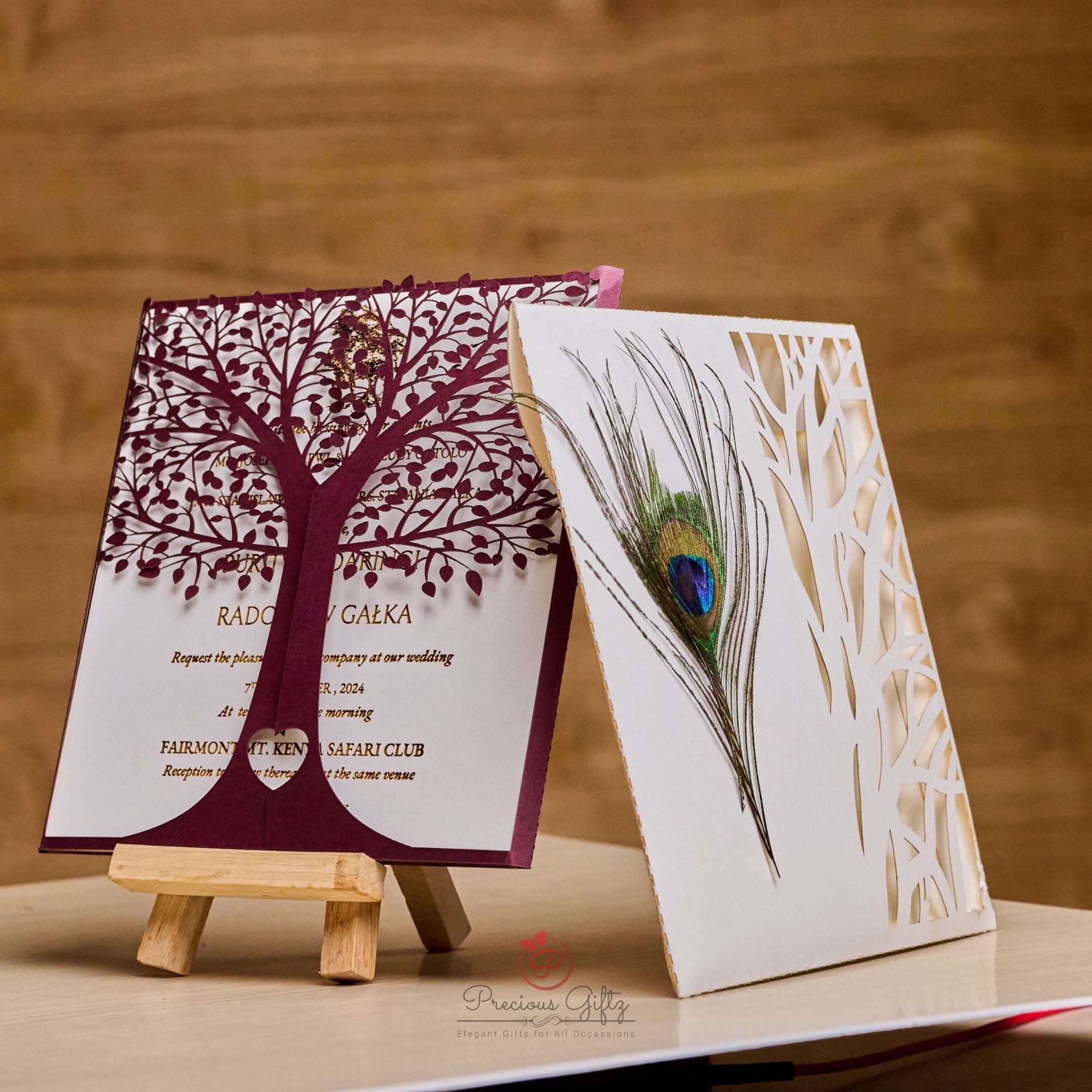 Peacock feather laser-cut wedding invitation with tree design