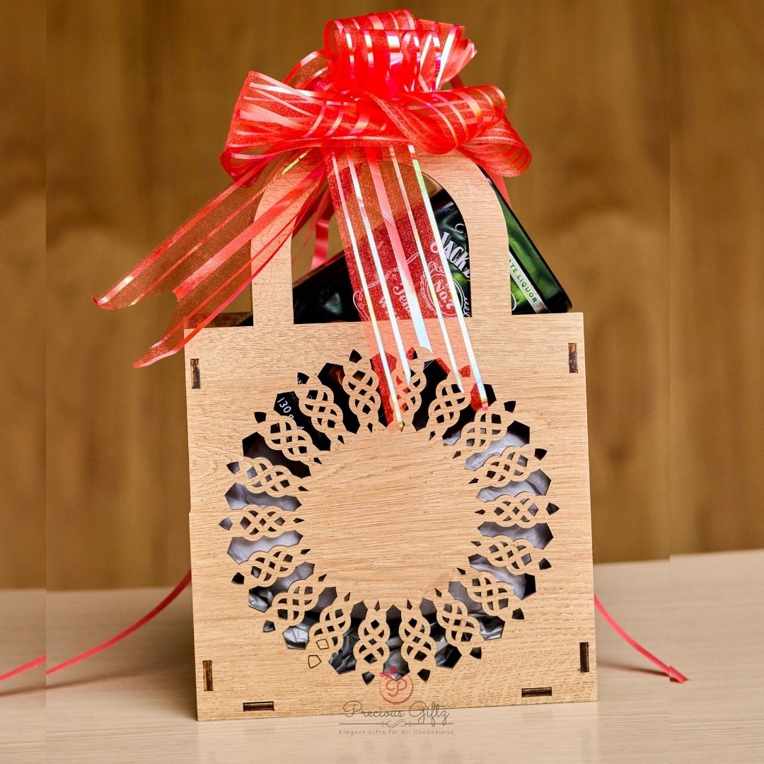Wooden wine bag with Celtic wreath cutout and red ribbon