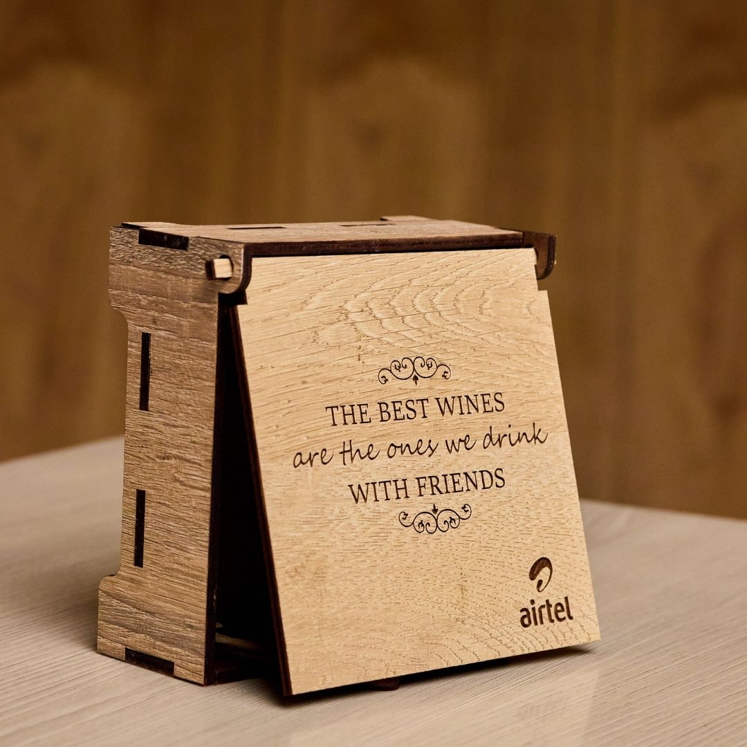 Airtel branded wooden coaster box with a friendship quote